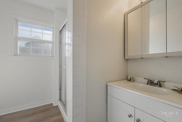 bathroom with vanity, wood-type flooring, and a shower with shower door