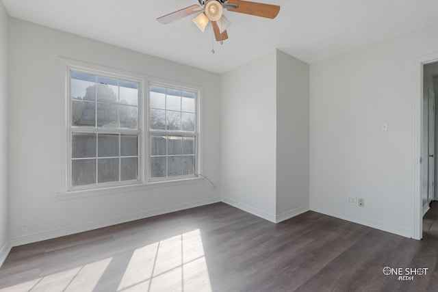 empty room with ceiling fan and dark hardwood / wood-style floors