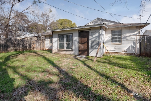 back of property with a lawn