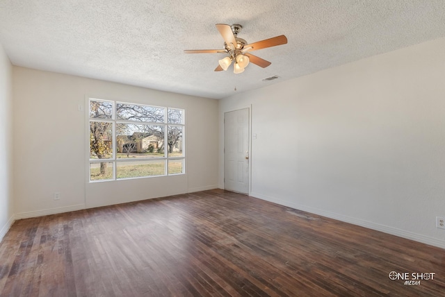 spare room featuring ceiling fan, dark hardwood / wood-style flooring, and a textured ceiling