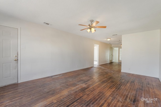 unfurnished room featuring a textured ceiling, dark wood-type flooring, and ceiling fan