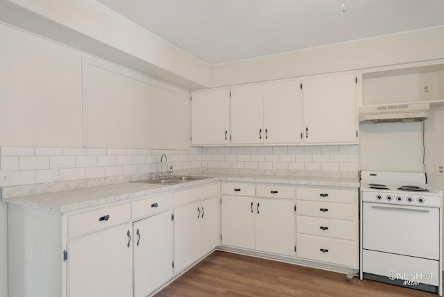 kitchen featuring white cabinetry, range, and sink