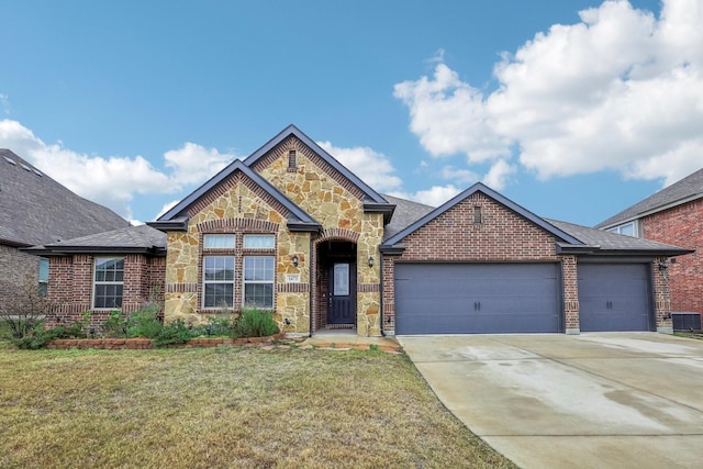 view of front of property with a front yard and a garage