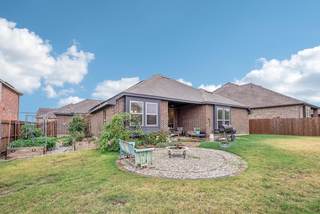 rear view of property featuring a lawn, a patio area, and an outdoor fire pit