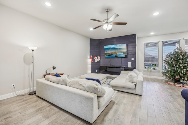 living room featuring light hardwood / wood-style floors and ceiling fan