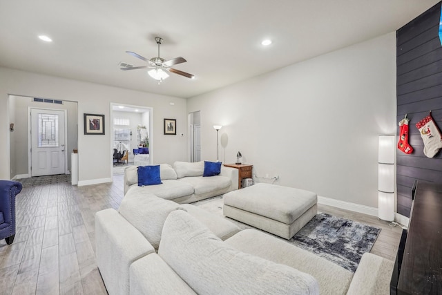 living room featuring light hardwood / wood-style floors and ceiling fan