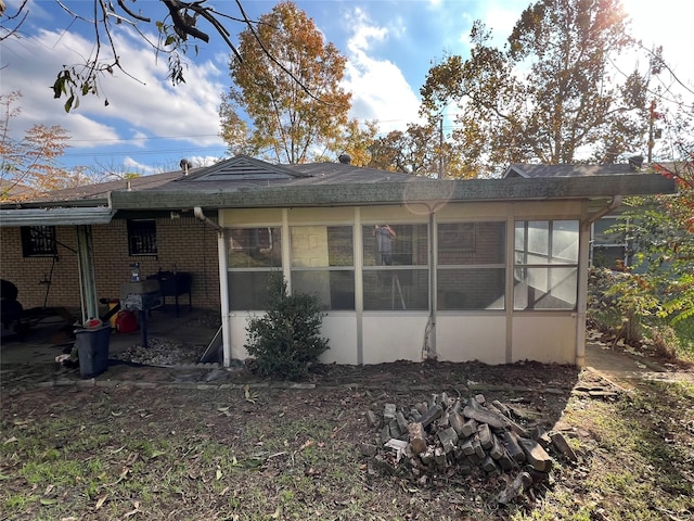 back of property with a sunroom