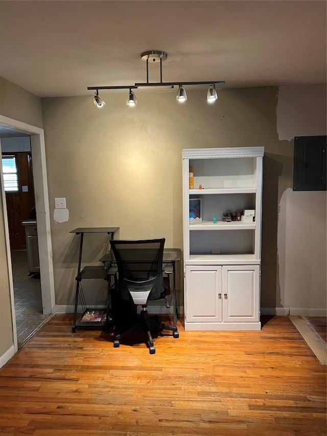 1019 W Bullock St, Denison, TX 75020 - office featuring electric panel, light wood-style flooring, baseboards, and track lighting