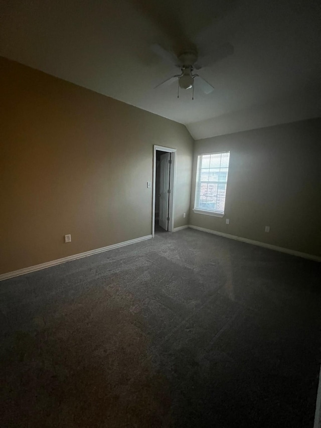 unfurnished room featuring ceiling fan, carpet floors, and lofted ceiling