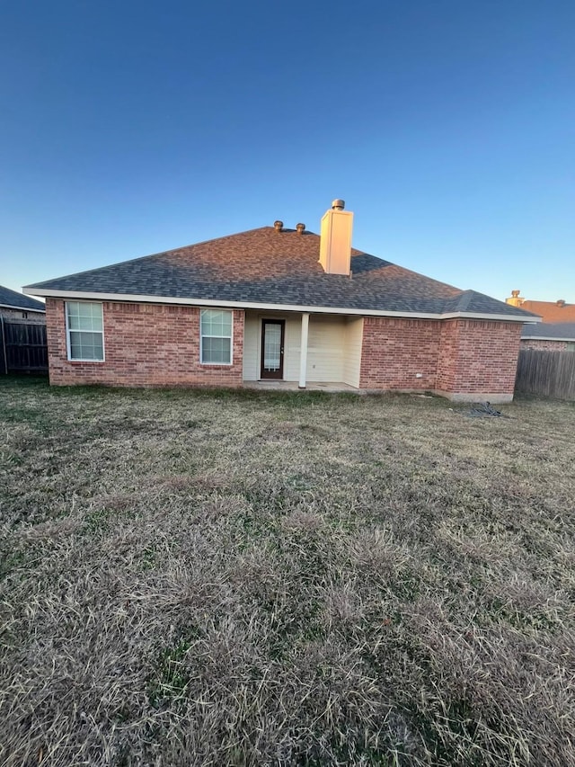 back of house with a lawn