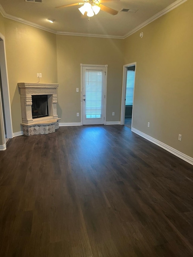 unfurnished living room featuring ornamental molding, ceiling fan, and dark wood-type flooring