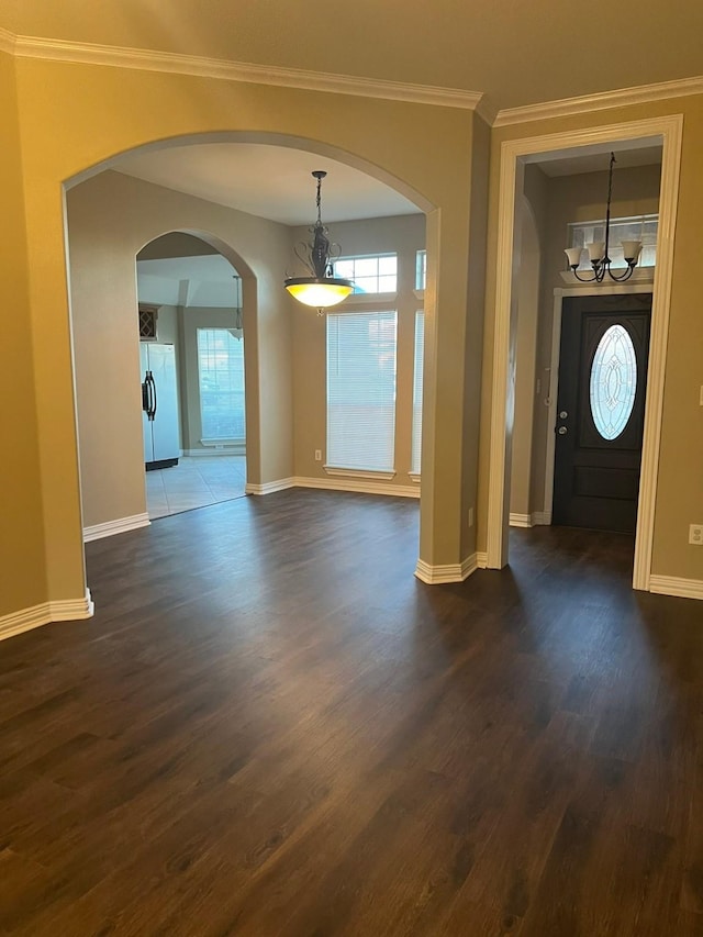 foyer entrance featuring dark hardwood / wood-style flooring and crown molding