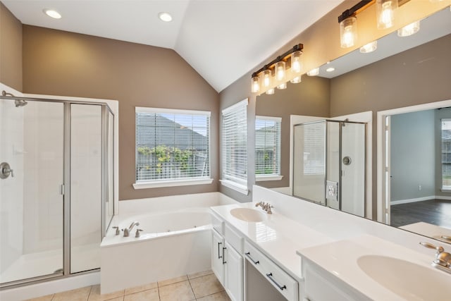 bathroom with tile patterned flooring, vanity, lofted ceiling, and plus walk in shower