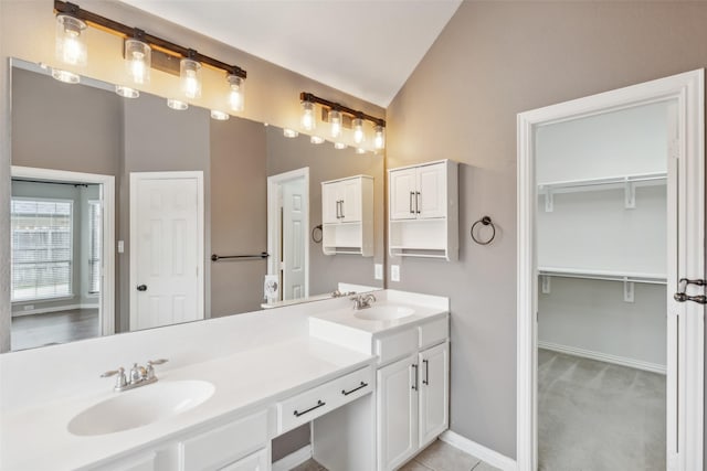 bathroom featuring vanity and lofted ceiling