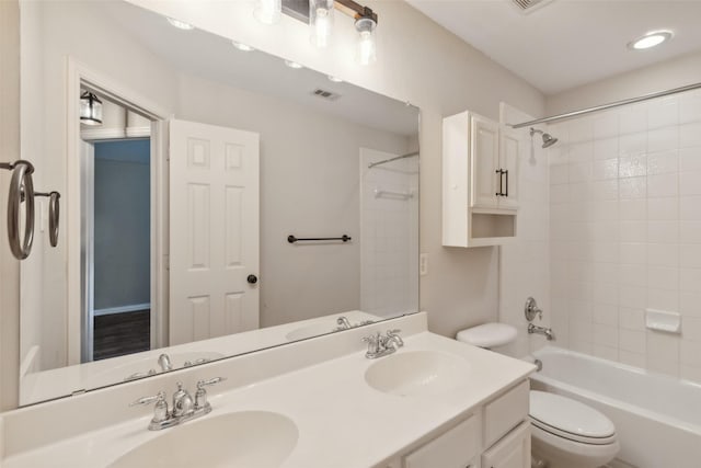 full bathroom featuring vanity, toilet, and tiled shower / bath