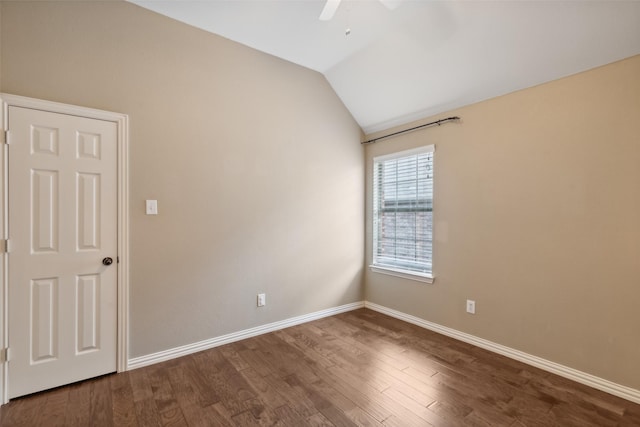 empty room with hardwood / wood-style floors, ceiling fan, and vaulted ceiling