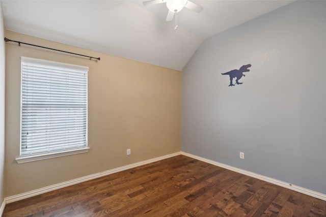 spare room with a wealth of natural light, dark hardwood / wood-style flooring, ceiling fan, and vaulted ceiling