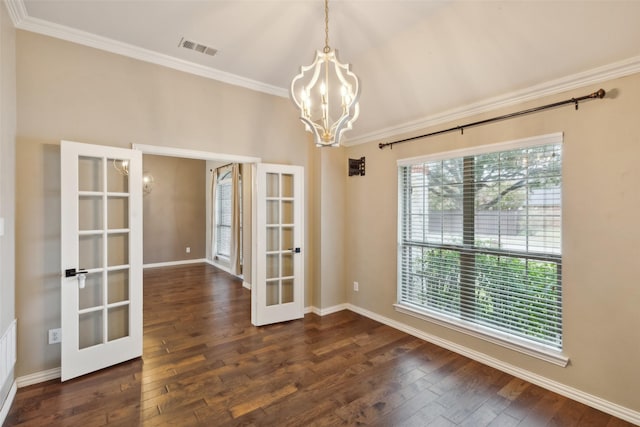 unfurnished dining area with a notable chandelier, dark hardwood / wood-style floors, ornamental molding, and french doors