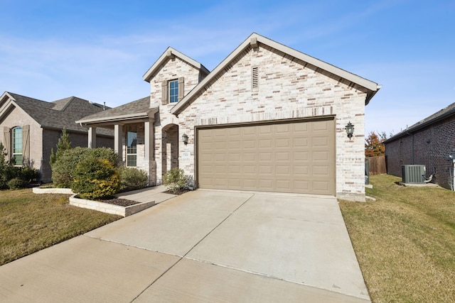 view of front of property with cooling unit, a garage, and a front yard