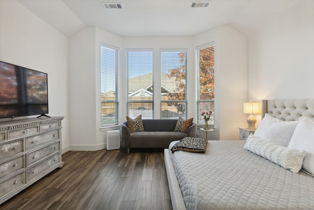 bedroom with dark wood-type flooring and lofted ceiling