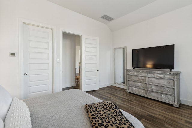 bedroom featuring dark wood-type flooring and vaulted ceiling