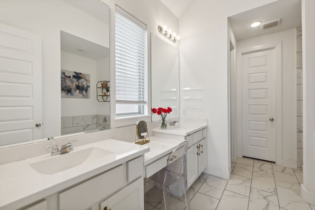 bathroom with a washtub and vanity