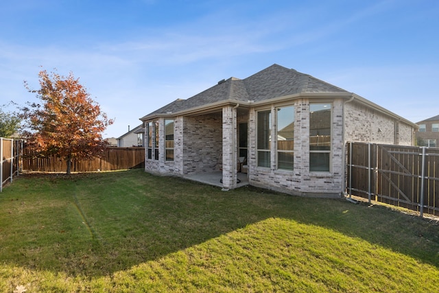 back of property featuring a yard and a patio area