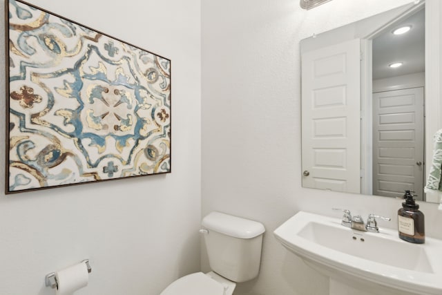 bathroom featuring toilet and sink