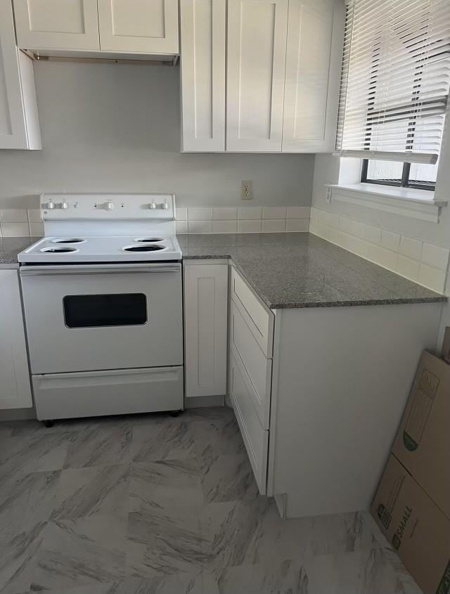 kitchen featuring white cabinetry, electric range, and stone countertops