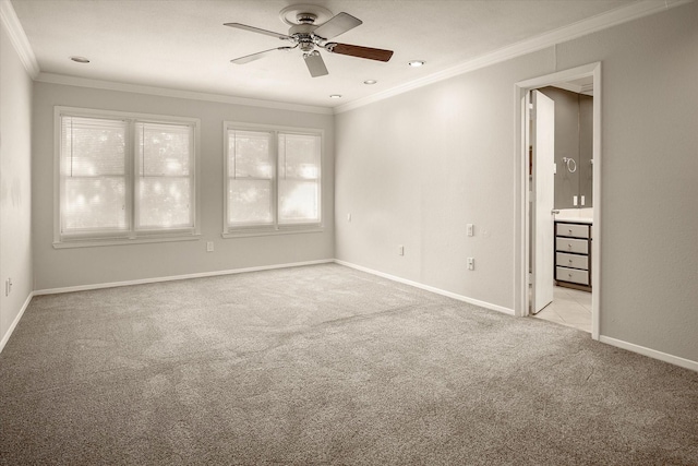 carpeted empty room with ceiling fan and crown molding