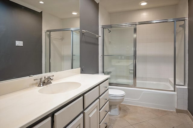 full bathroom with shower / bath combination with glass door, vanity, toilet, and tile patterned flooring