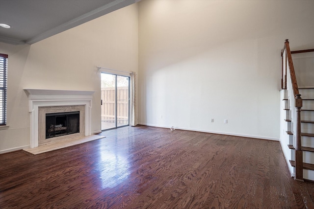 unfurnished living room with dark hardwood / wood-style flooring