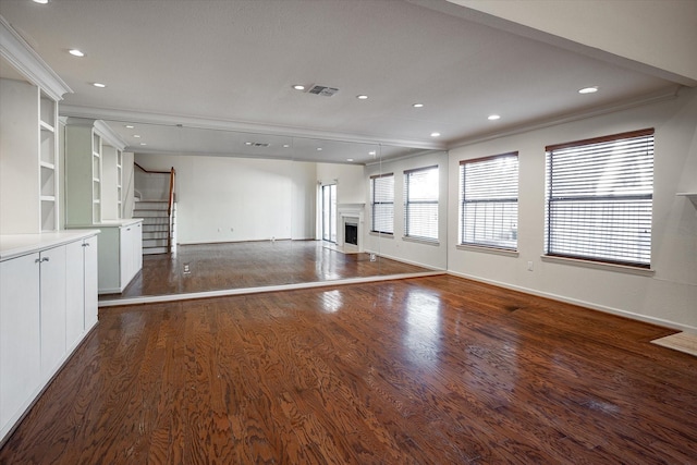 unfurnished living room featuring dark hardwood / wood-style floors and crown molding