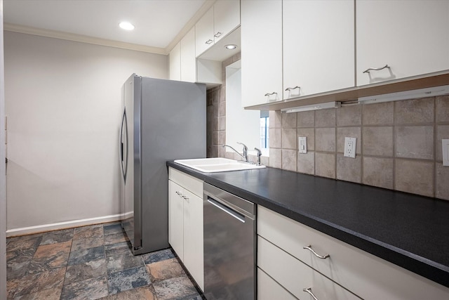 kitchen featuring appliances with stainless steel finishes, tasteful backsplash, crown molding, sink, and white cabinets