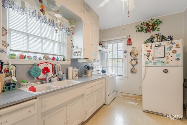 kitchen featuring white cabinetry, sink, and white appliances