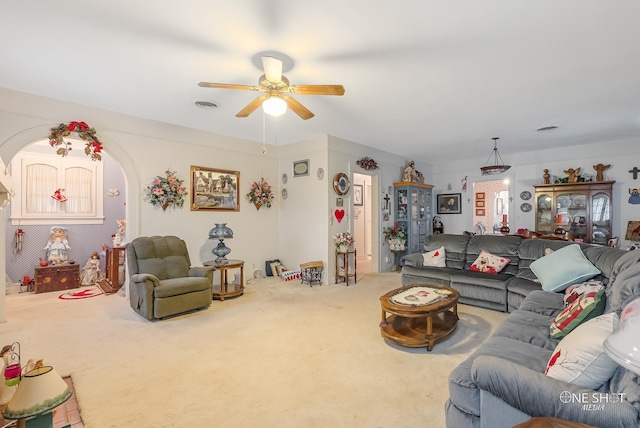 living room featuring carpet and ceiling fan