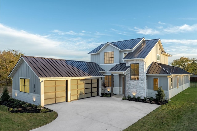 modern farmhouse style home with a front lawn and a garage