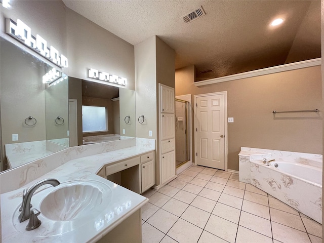 bathroom with a textured ceiling, vanity, tile patterned floors, and separate shower and tub