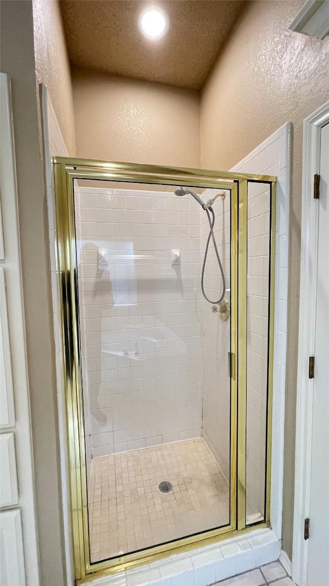 bathroom featuring a shower with shower door