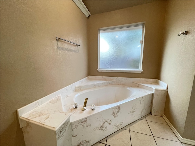 bathroom with tile patterned floors and a tub