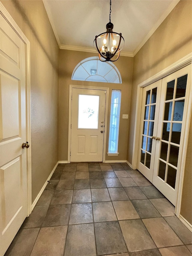 foyer entrance featuring french doors, an inviting chandelier, and crown molding