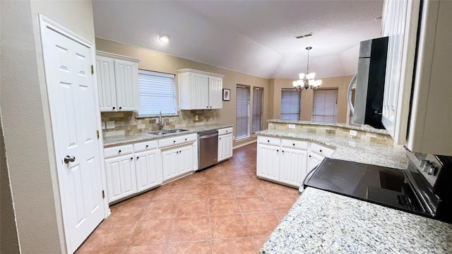 kitchen featuring dishwasher, sink, a chandelier, lofted ceiling, and white cabinets