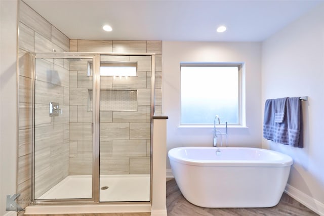 bathroom featuring independent shower and bath and hardwood / wood-style flooring