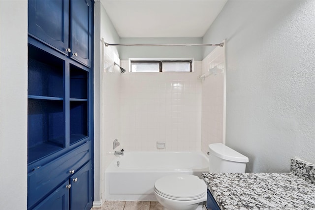 full bathroom featuring tiled shower / bath combo, vanity, tile patterned floors, and toilet