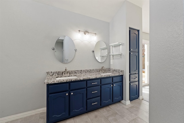 bathroom with tile patterned flooring and vanity