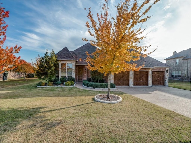 view of front of house featuring a front yard and a garage