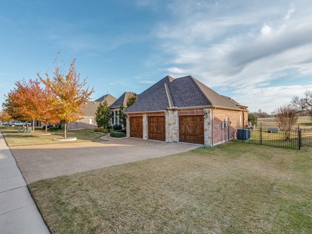 view of side of property featuring a lawn and central AC