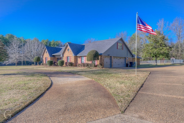 view of front of house featuring a garage and a front yard