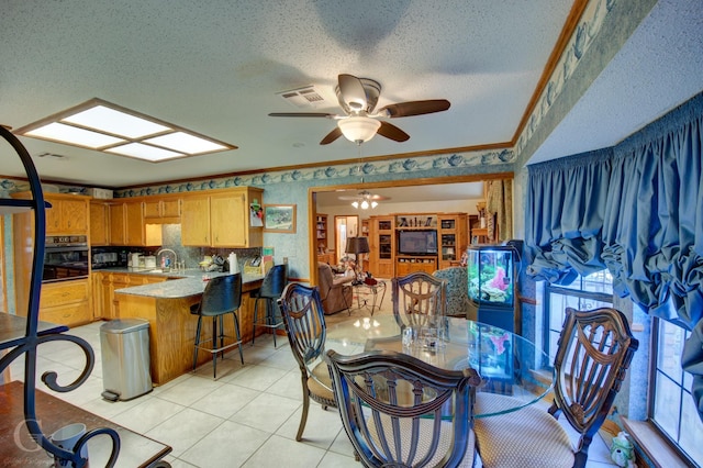 111 White Rd, Frierson, LA 71027 - dining room with sink, light tile patterned floors, ceiling fan, crown molding, and a textured ceiling