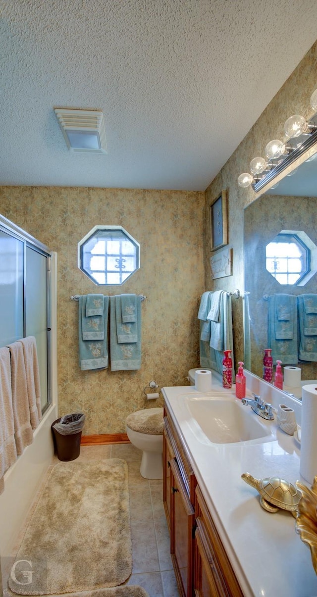 111 White Rd, Frierson, LA 71027 - full bathroom featuring toilet, shower / bath combination with glass door, a textured ceiling, vanity, and tile patterned flooring